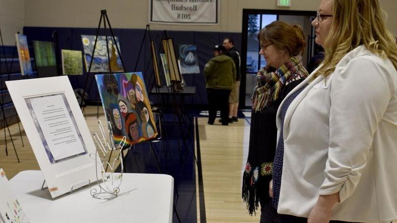 Attendees view some of the artwork submitted at the annual campus and community art show, hosted by the IDREAM Team at Penn State DuBois.